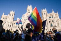 A protester waves a Pride flag in Madrid, Spain