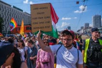 Polish LGBT activist Bartosz Staszewski holds a sign saying 'LGBT free zones'