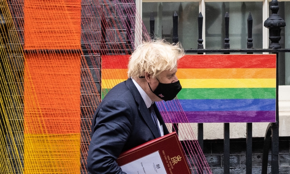 Boris Johnson walks beneath the Pride Month installation outside number 10