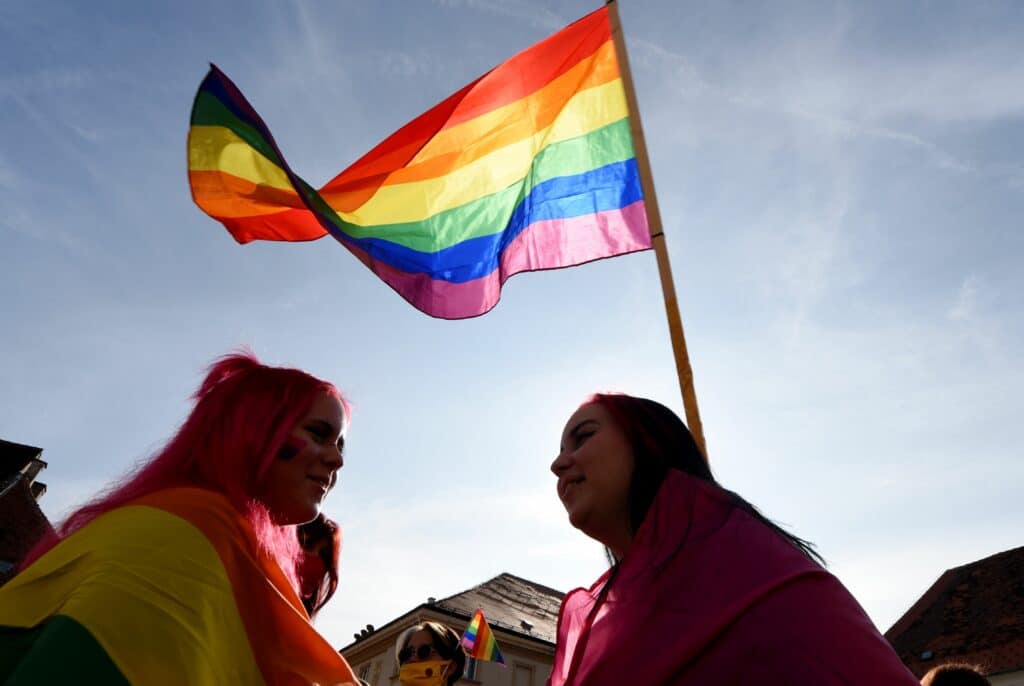A woman holds a rainbow flag as people take part in the 19th Gay Pride Parade in downtown Zagreb