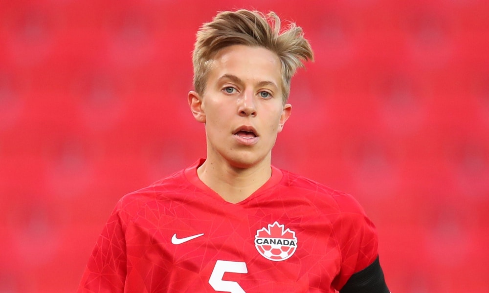 Quinn of Canada in a red football top with the Nike logo and Canadian maple leaf