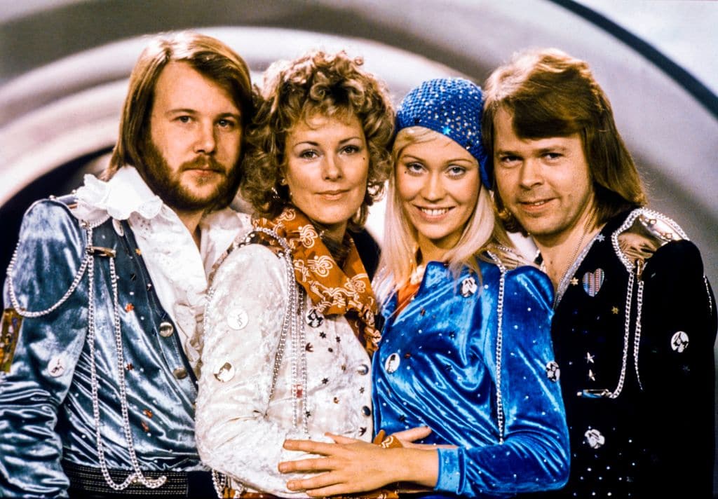 The four original members of ABBA posing for a photo together after winning the Eurovision Song Contest