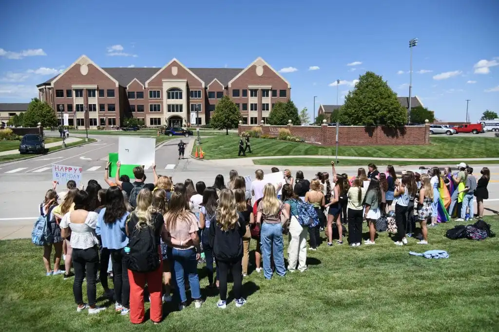 About 50 Valor Christian High School students walked out of classes to support a volleyball coach Inoke Tonga, who says he was forced to leave his job over his sexuality, in front of the high school in Highlands Ranch, Colorado on Tuesday, August 24, 2021.
