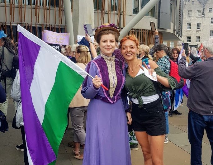 Anti-trans protesters who booed Nicola Sturgeon pose in suffragette colours