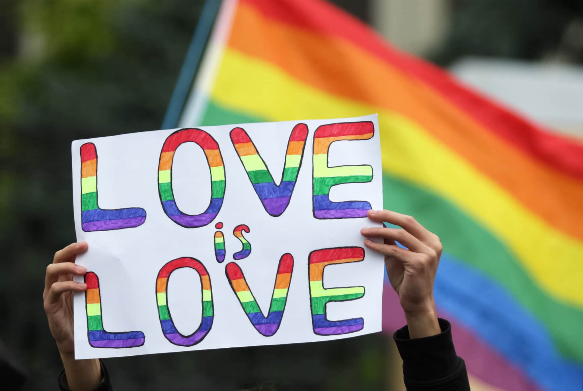 A participant holds a placard which says Love is love during the Equality March KyivPride 2021 of the LGBT community.