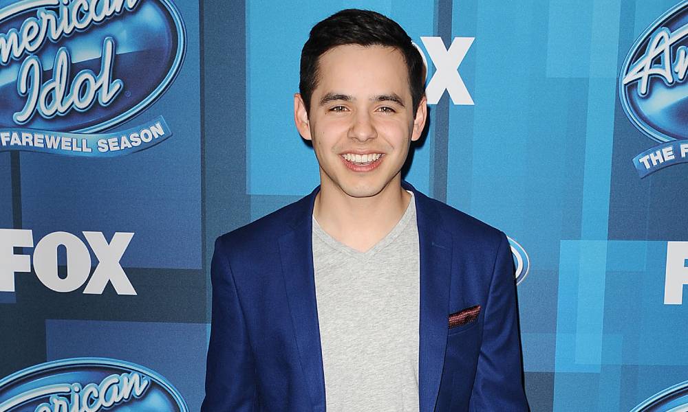 David Archuleta attends FOX's "American Idol" finale for the farewell season at Dolby Theatre in a blue suit jacket and grey shirt