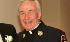 Fire Department chaplain Mychal Judge smiles for a photograph 28 July 2001, Judge was killed in the 9/11 attack later that year