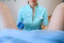 nurse performs cervical screening on person with cervix