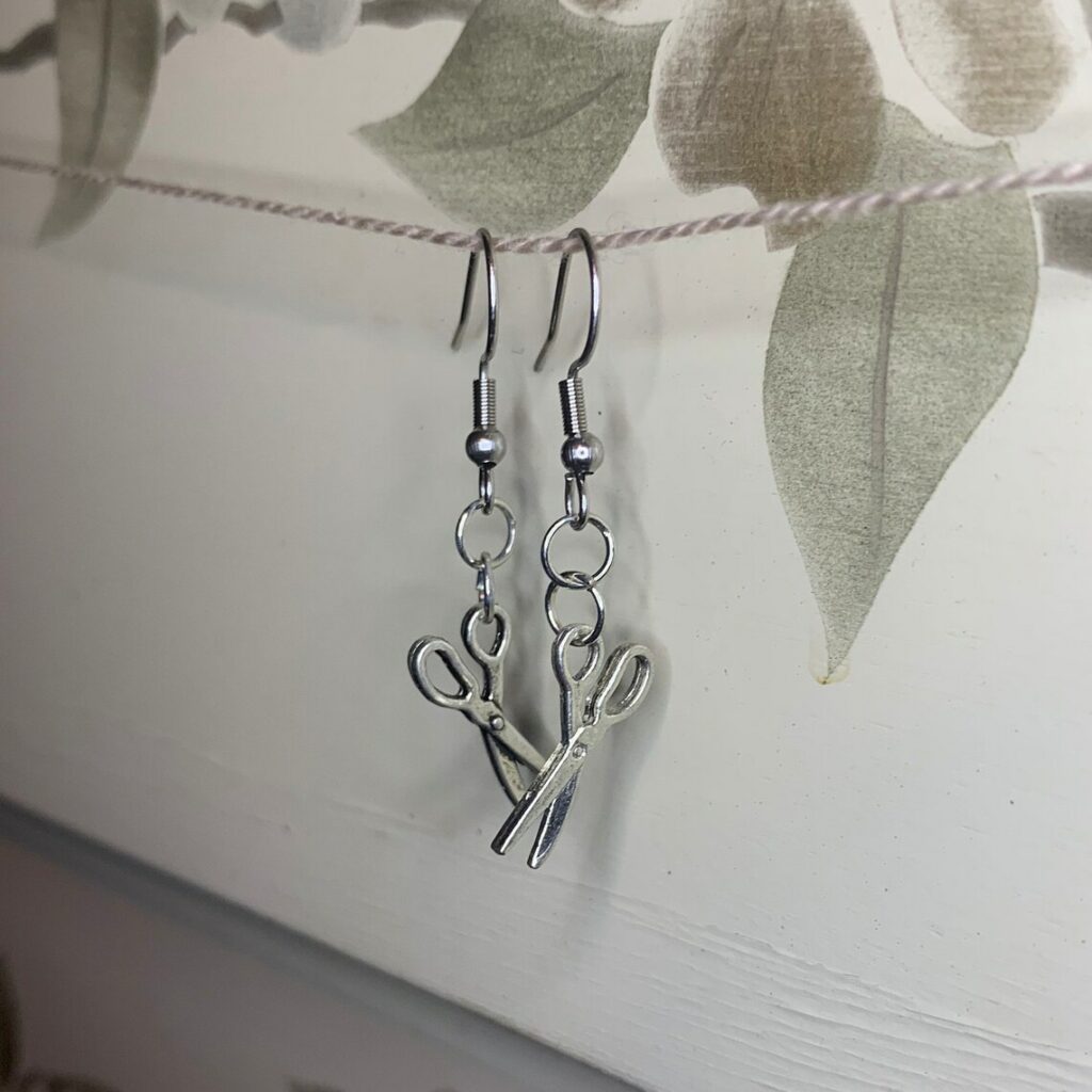 These cute scissor earrings are perfect for a queer Halloween. 