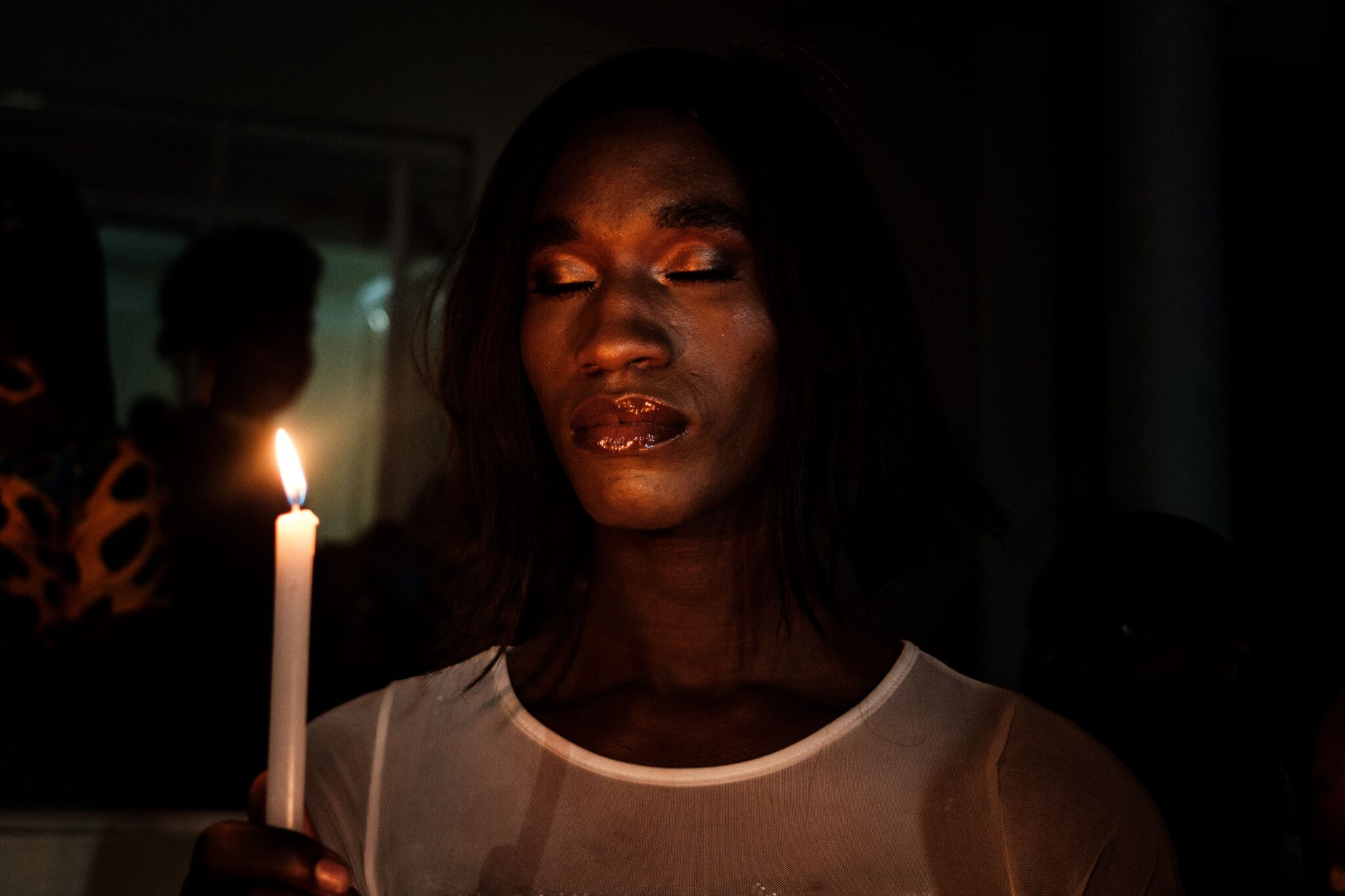 A member of the trans community holds candles during the vigil of the Transgender day of Remembrance