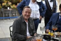 Kevin Spacey is seen sitting outside a cafe