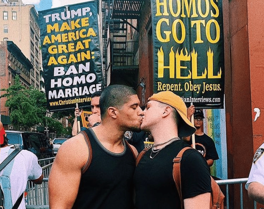 Anthony Bowens kisses boyfriend in front of crowd of homophobic protesters