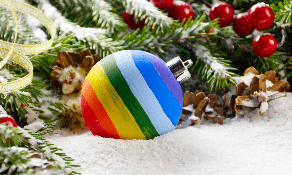 A rainbow bauble on a bed of snow