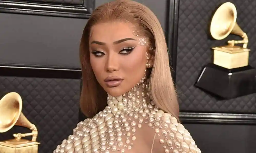 Nikita Dragun is seen in a nude dress with pear-like accents at the Grammy Awards in 2020