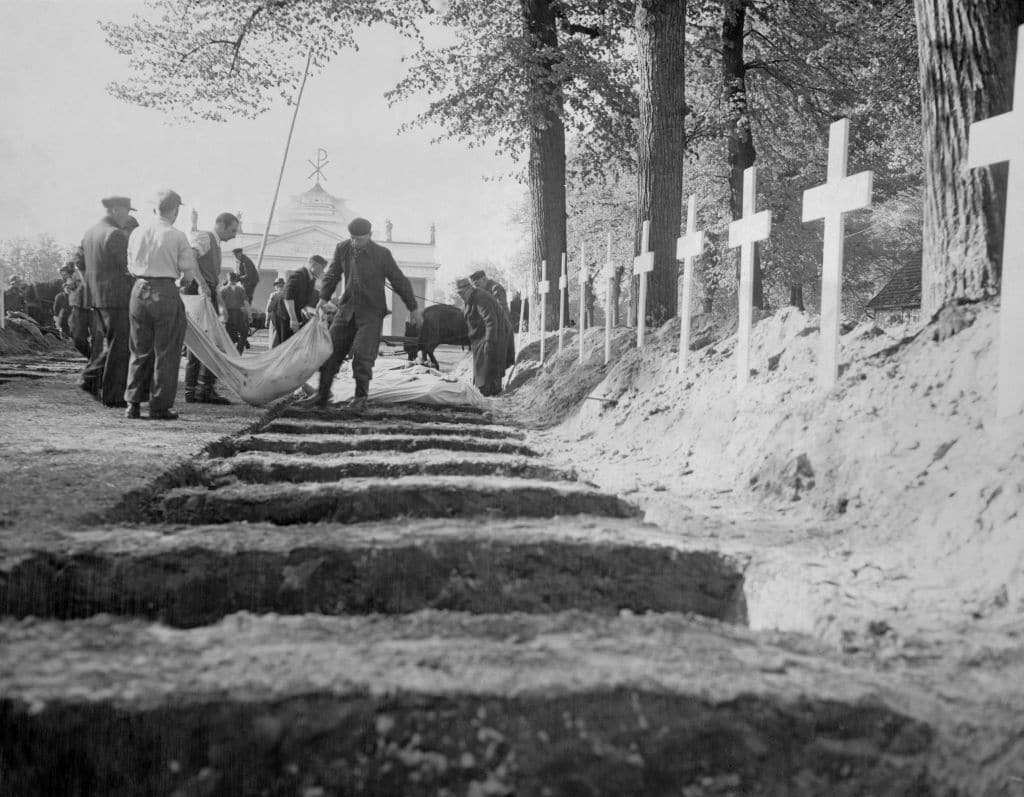 German civilians from the town of Ludwigslust are forced to bury victims of Nazi Germany's effort to exterminate the Jewish population, political and social dissidents, homosexuals, gysies and prisoners of war amongst many others.