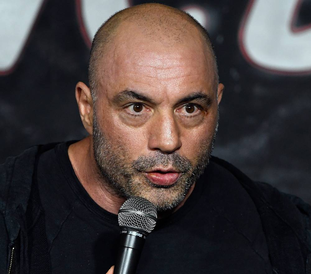Joe Rogan holds a microphone during an appearance at the Ice House Comedy Club