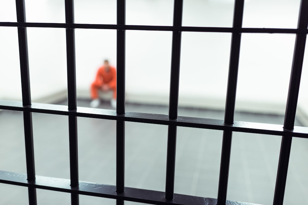 A prisoner behind bars.