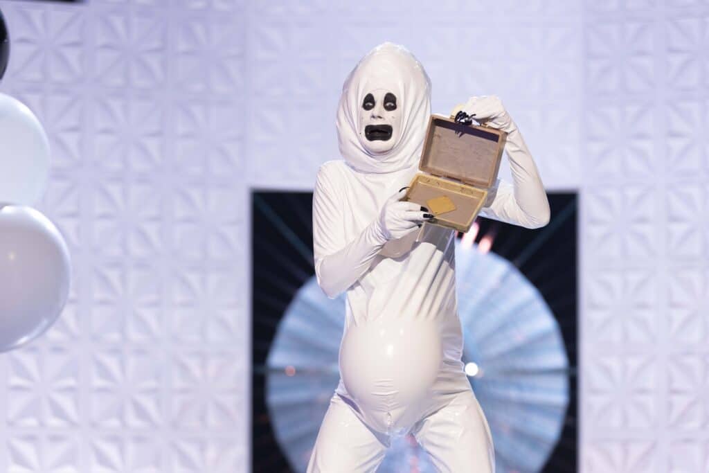 Jimbo in a white latex costume, looking like a ghost sperm cell