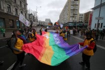 Activists hold the rainbow flag on Volodymyrska Street during the Equality March.