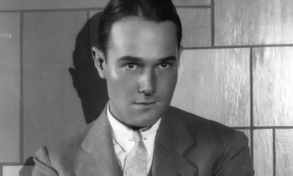 William Haines, a white man, wears a suit and a tie in a black and white photo