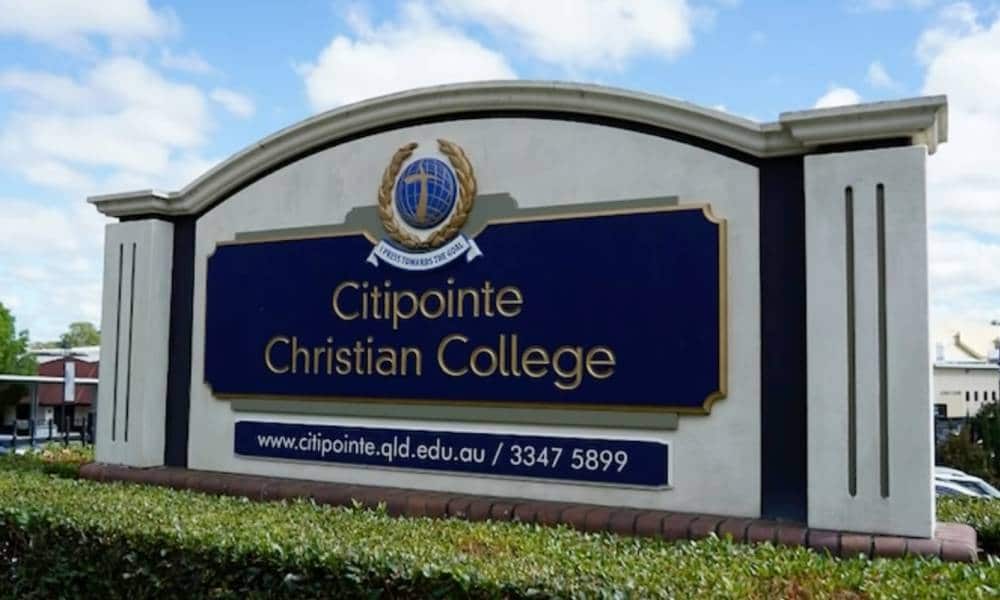A sign for Citipointe Christian College in Australia surrounded by shrubbery
