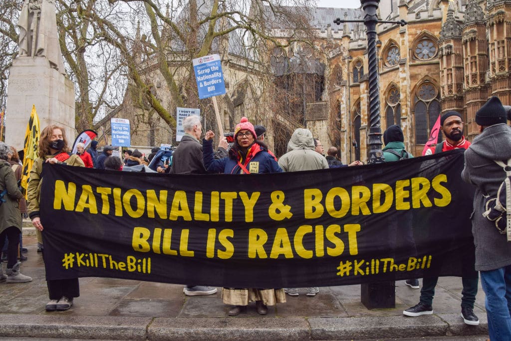 Demonstrators hold a 'Nationality and Borders Bill Is Racist' banner during the protest.
