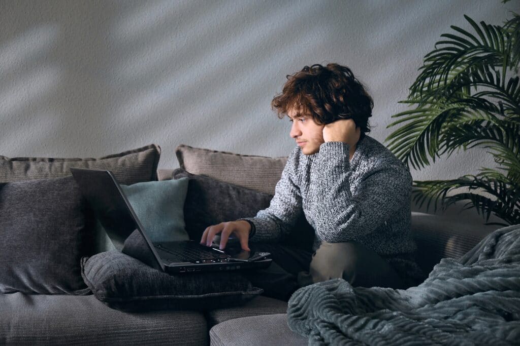 Man using a laptop in his living room
