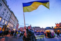 A protester waves a Ukrainian flag during a protest in Krakow, Poland.
