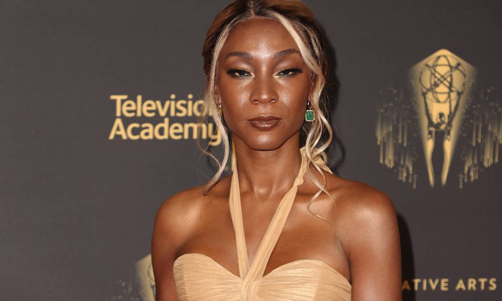 Angelica Ross wears a peach, gold coloured dress
