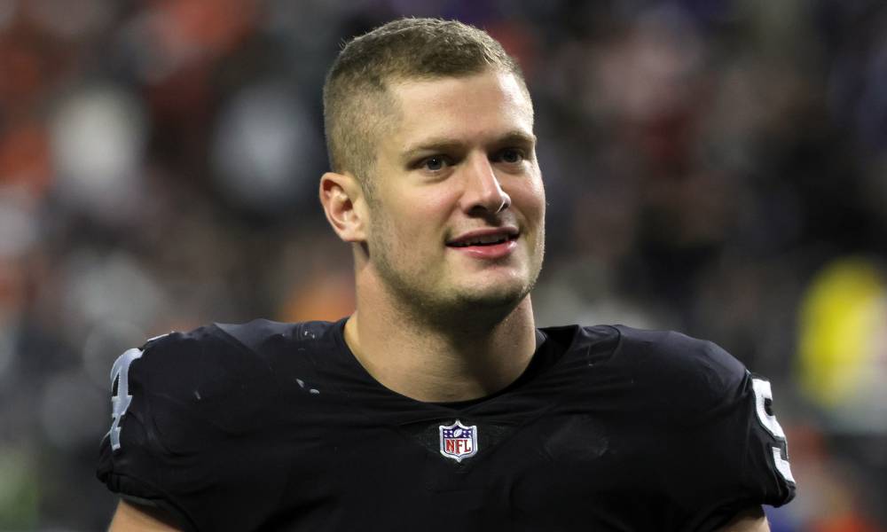 Carl Nassib, a player for the Las Vegas Raiders, walks off the field while wearing a football jersey