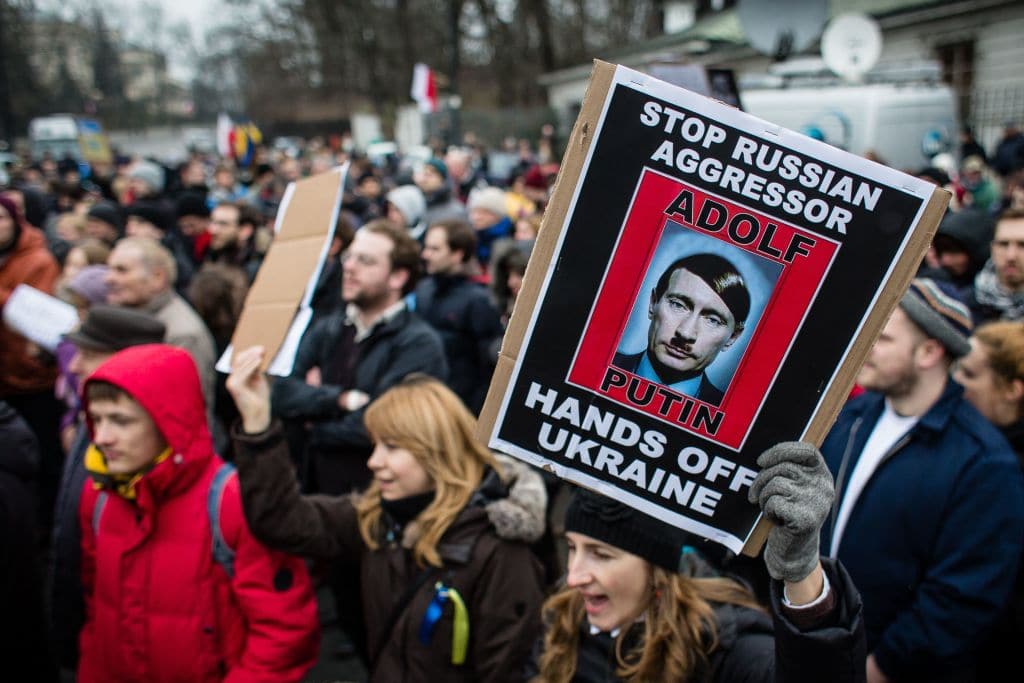 People protest in front of Russian embassy against Russian military action the Crimean peninsula during a pro-peace demonstration on March 2, 2014 in Warsaw. 