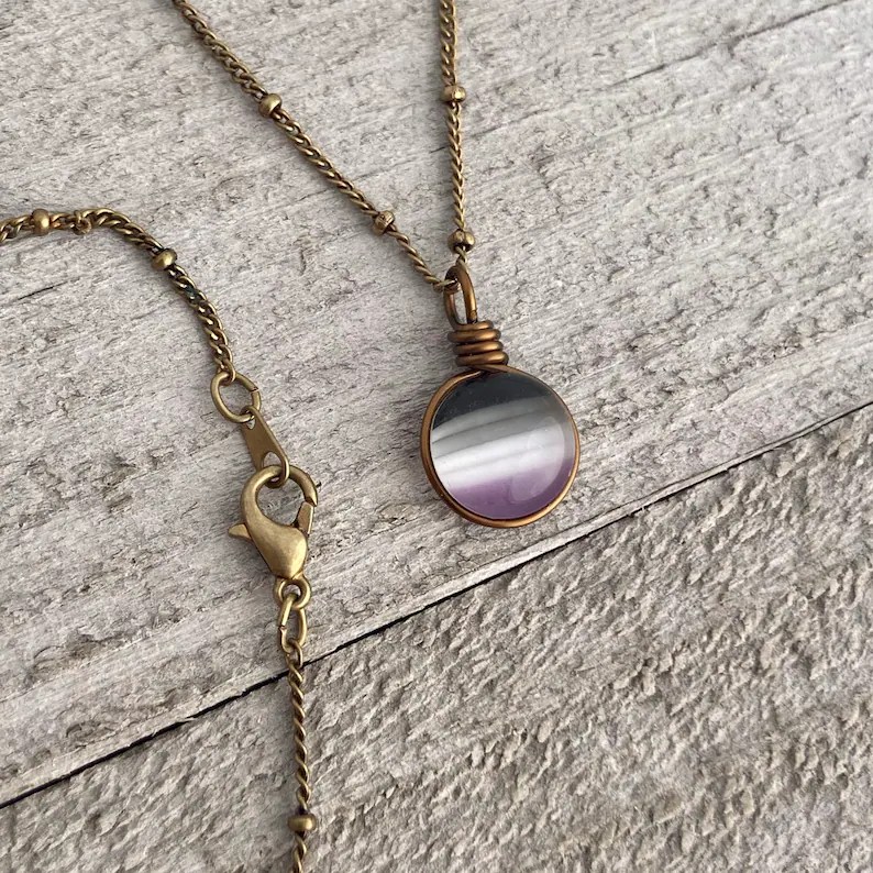 An asexual Pride flag necklace. 