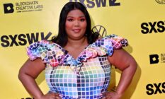 Lizzo wears a colourful, rainbow block outfit as she stands in front of a yellow background with the black SXSW logo on it