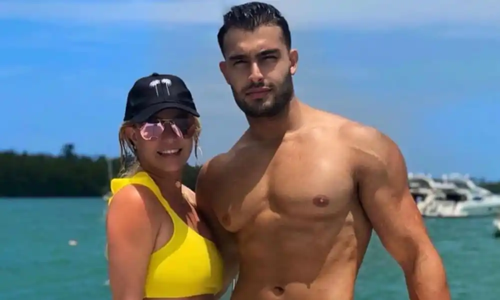 Sam Asghari and Britney Spears pose by the sea