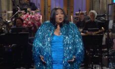 Lizzo wears a bright blue dress and a sparkly blue jacket during her opening monologue on Saturday Night Live