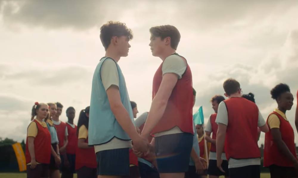 a still image of Heartstopper characters Nick and Charlie on a rugby field