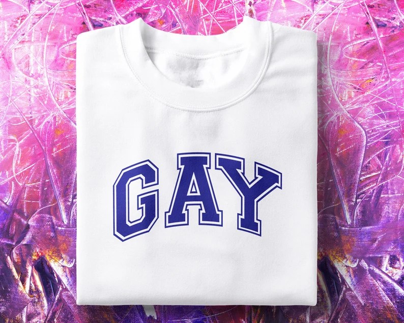A 90s-style t-shirt that says "GAY". (TheInternetClubUK/Etsy)