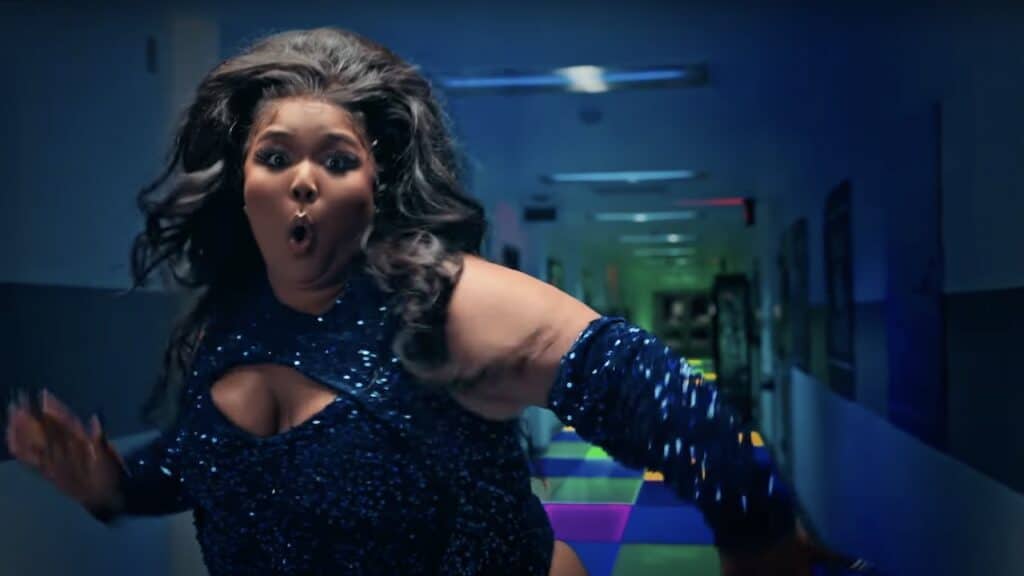 Lizzo in sequins, dancing in front of a hallway with a light-up floor