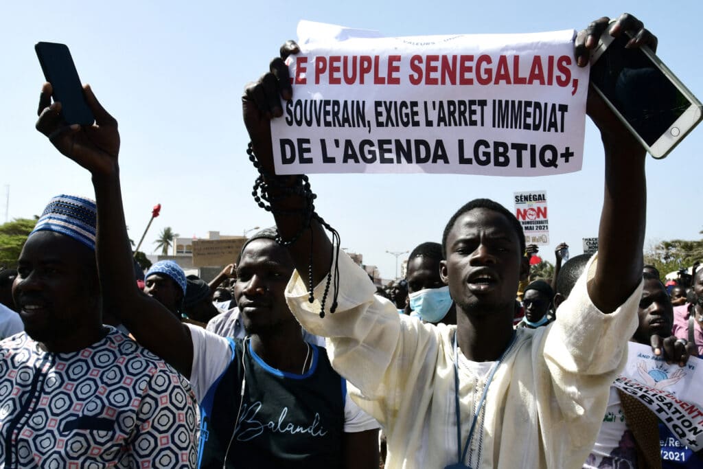 A protester in Dakar holds a sign reading 'No to LGBTQ+ agenda'.