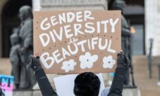 A person holds up a sign that reads "Gender Diversity is Beautiful" during a rally supporting trans youth