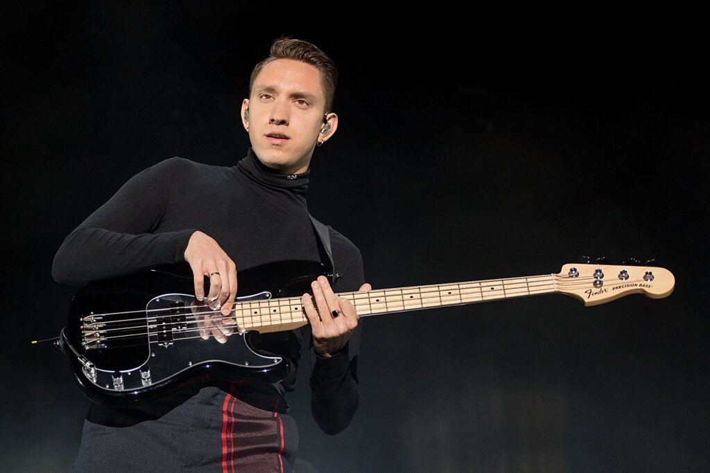 Oliver Sim of The xx performs on his bass guitar