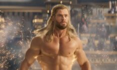 Chris Hemsworth as Marvel character Thor stands without a shirt as lightning trails behind him in the trailer for Thor: Love and Thunder