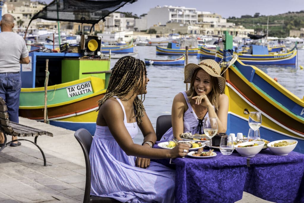 Two women dining on a Maltese street