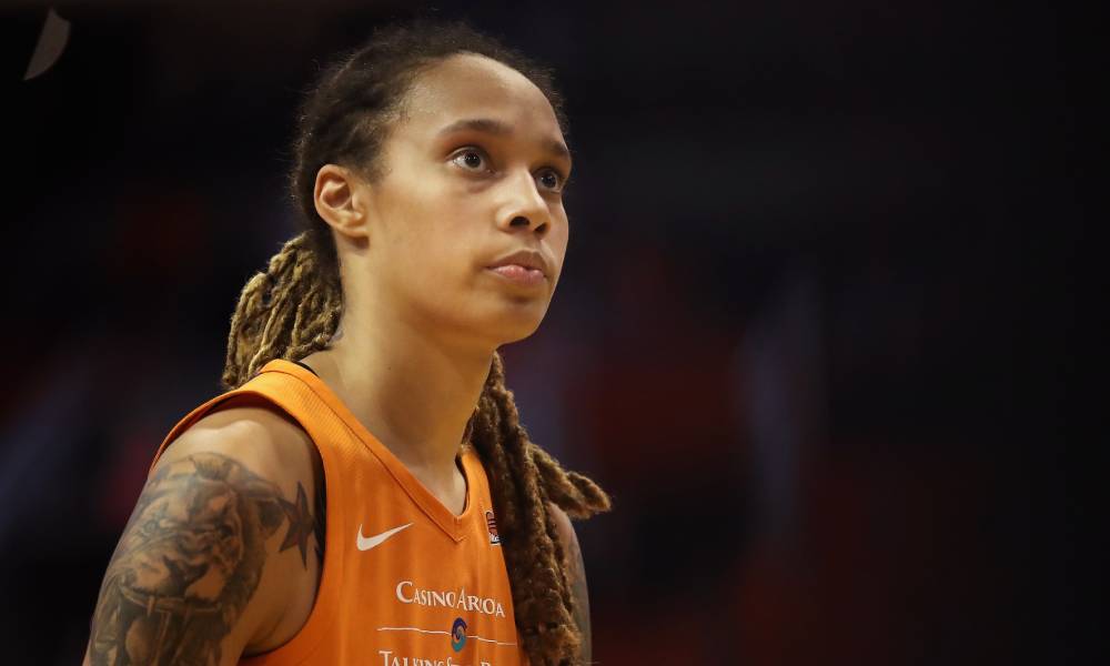 US basketball star Brittney Griner wears an orange jersey while looking up