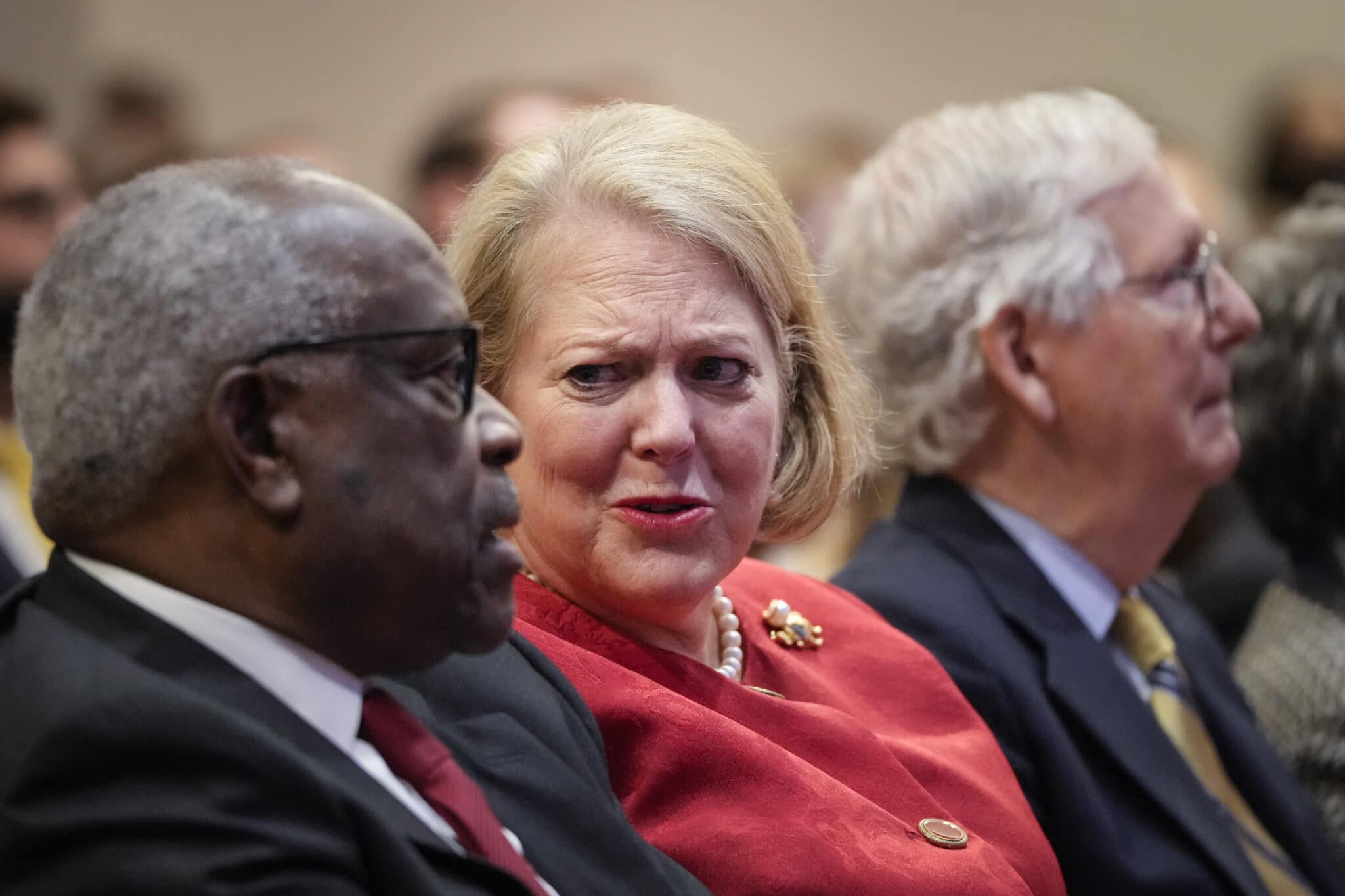 Justice Clarence Thomas sits with his wife and conservative activist Virginia Thomas while he waits to speak at the Heritage Foundation 