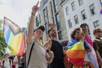 People walk through Oslo holding Pride flags
