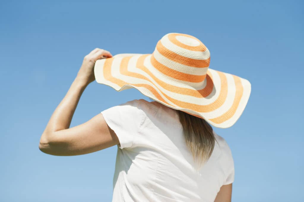 Woman wearing a sun hat looking away from the camera