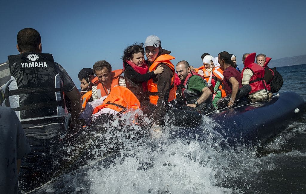 Refugees get off the boat after it arrived in Lesbos Island, Greece on September 17, 2015.