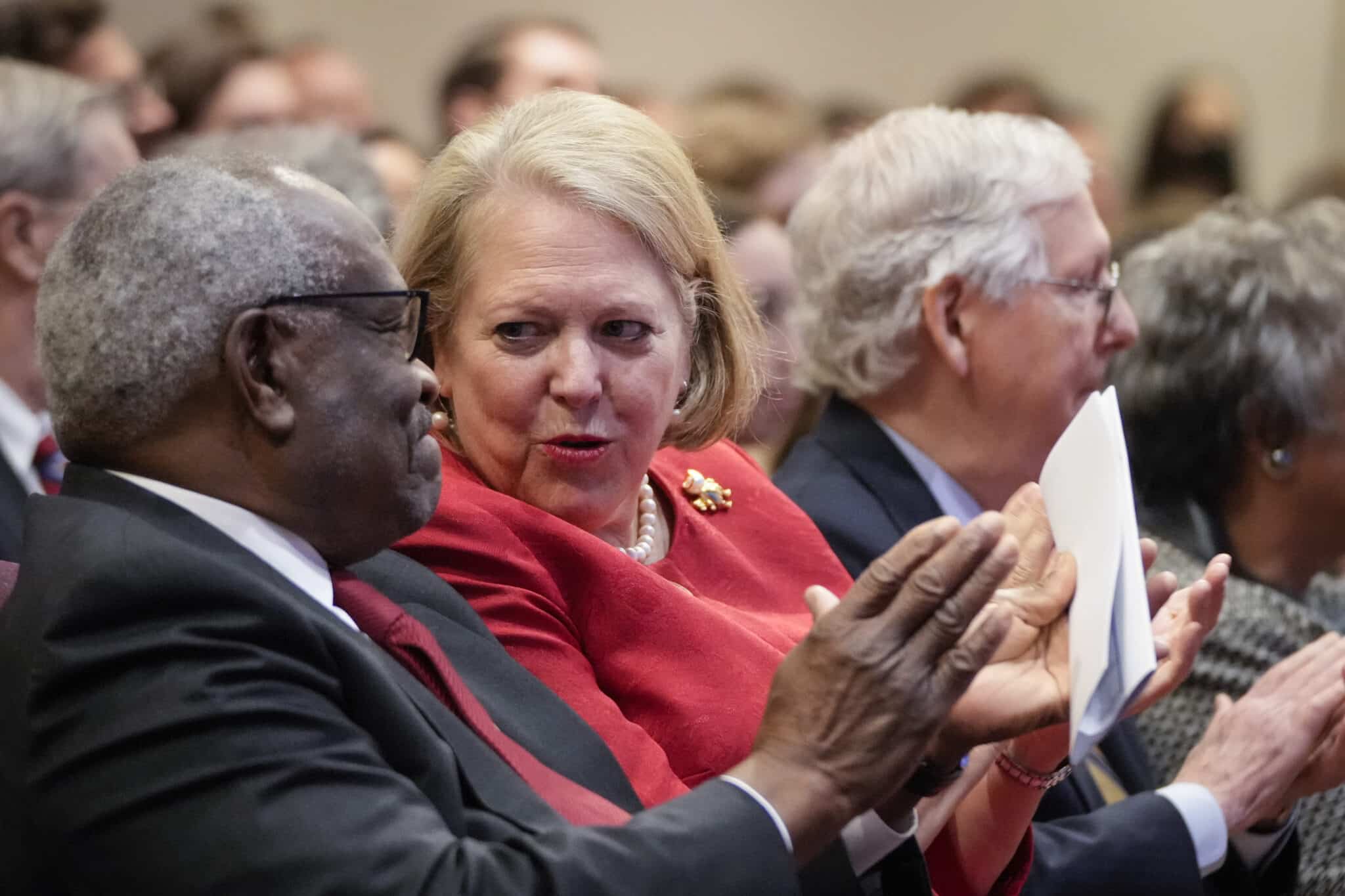 (L-R) Associate Supreme Court Justice Clarence Thomas sits with his wife and conservative activist Virginia Thomas while he waits to speak at the Heritage Foundation on October 21, 2021 in Washington, DC.