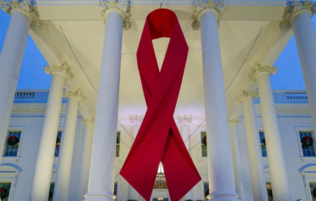 A large red ribbon is seen on the White House